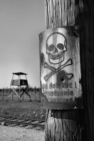 Concentration camp AUSCHWITZ BIRKENAU fences achtung minen skull metal sign