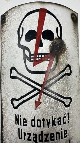 Concentration camp AUSCHWITZ BIRKENAU fences achtung minen skull metal sign