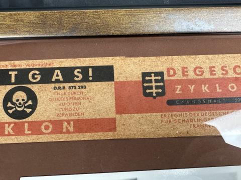 Zyklon B canister label in frame with holocaust photo Concentration Camp
