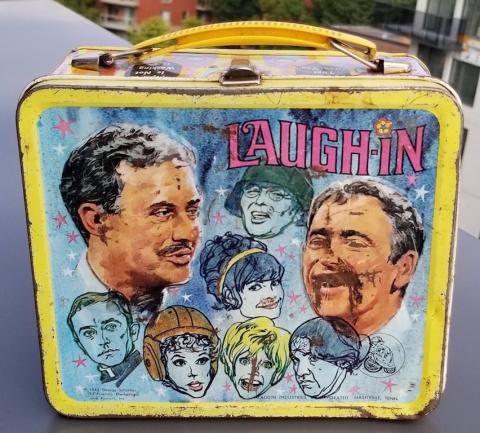 POST-WAR AMERICAN TV-SHOW LAUGH-IN - SOCK-IT-TO-ME LUNCH BOX SHOWING THE ACTOR WITH A GERMAN HEER WEHRMACHT HELMET WITH A NICE DECAL WITH SWASTIKA