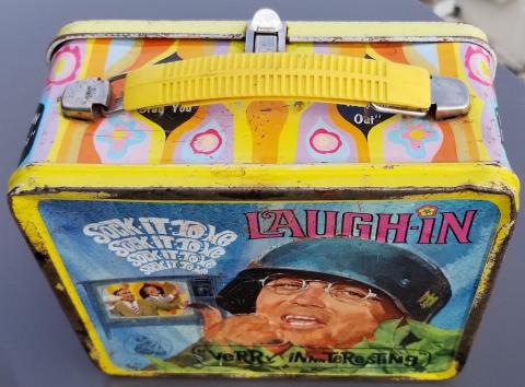 POST-WAR AMERICAN TV-SHOW LAUGH-IN - SOCK-IT-TO-ME LUNCH BOX SHOWING THE ACTOR WITH A GERMAN HEER WEHRMACHT HELMET WITH A NICE DECAL WITH SWASTIKA