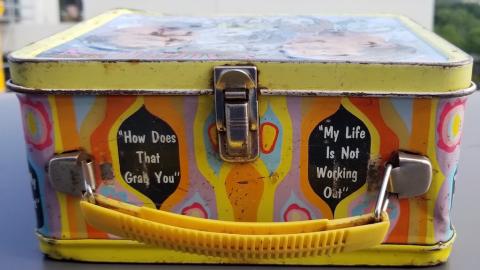 POST-WAR AMERICAN TV-SHOW LAUGH-IN - SOCK-IT-TO-ME LUNCH BOX SHOWING THE ACTOR WITH A GERMAN HEER WEHRMACHT HELMET WITH A NICE DECAL WITH SWASTIKA