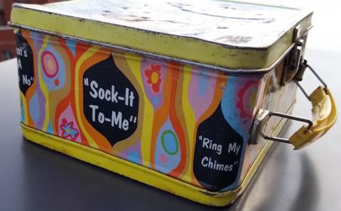 POST-WAR AMERICAN TV-SHOW LAUGH-IN - SOCK-IT-TO-ME LUNCH BOX SHOWING THE ACTOR WITH A GERMAN HEER WEHRMACHT HELMET WITH A NICE DECAL WITH SWASTIKA