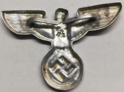 WW2 German Nazi NSDAP M36 head left facing metal visor cap insignia eagle marked by Assmann