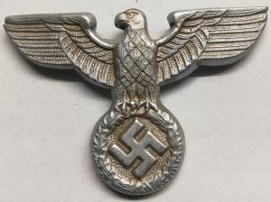 WW2 German Nazi NSDAP M36 head left facing metal visor cap insignia eagle marked by Assmann